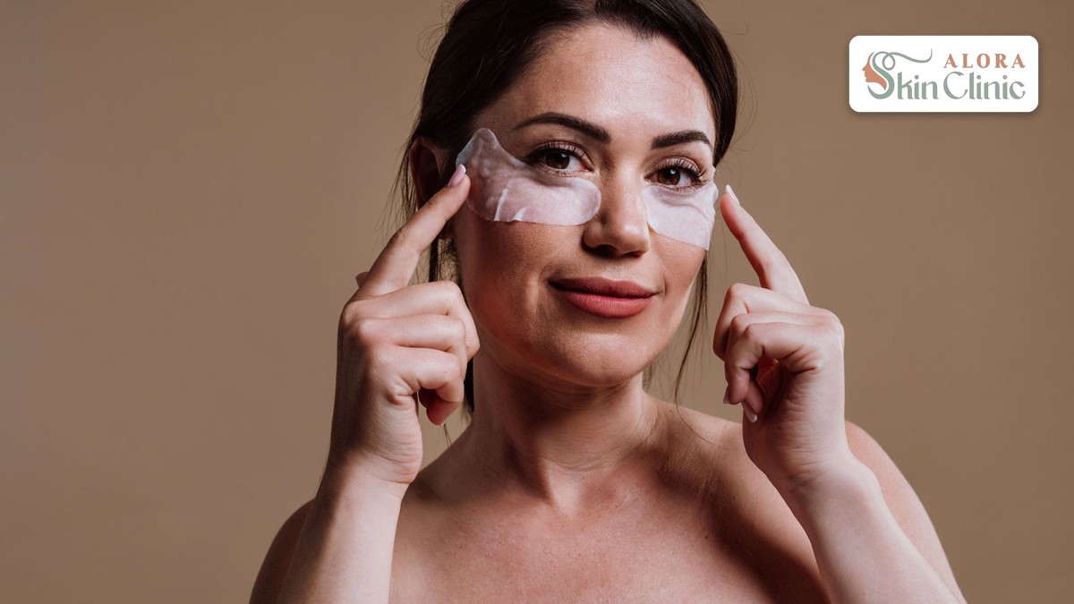 Woman applying under-eye patches to freshen tired-looking eyes