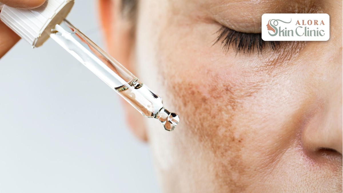 Serum being applied to the cheek as part of a skincare routine for pores