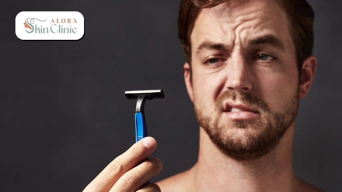 Man holding a razor, frustrated by shaving and recurring ingrown hairs